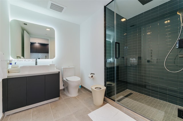 bathroom with vanity, a shower with shower door, tile patterned floors, and toilet