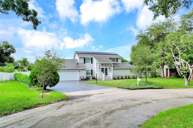 view of front of property with a garage and a front yard