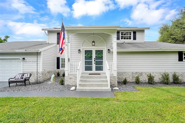 view of front of property featuring a garage and a front lawn