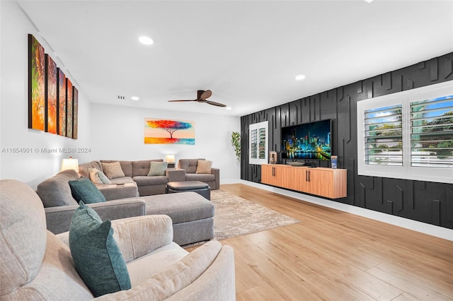 living room featuring hardwood / wood-style flooring and ceiling fan