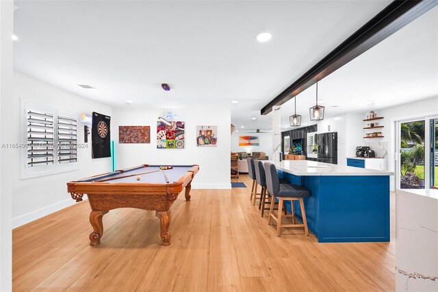 game room with light wood-type flooring, billiards, and indoor bar