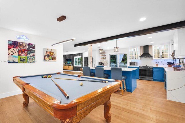 playroom with light wood-type flooring, bar area, and billiards