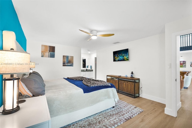 bedroom with ceiling fan and light wood-type flooring