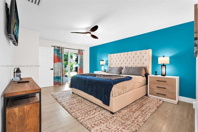 bedroom with ceiling fan, hardwood / wood-style flooring, and access to outside