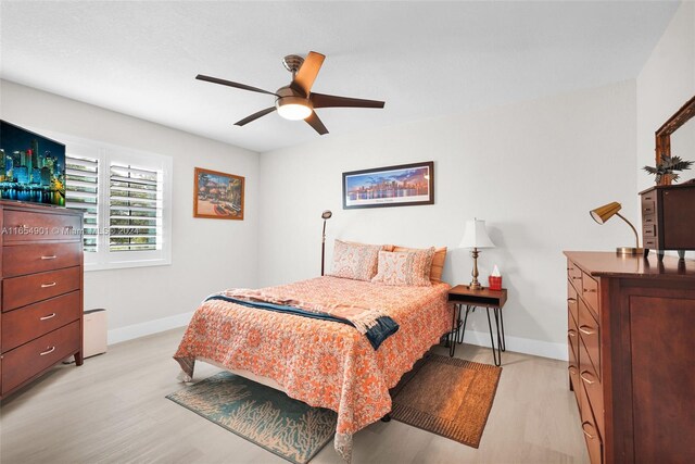 bedroom featuring light hardwood / wood-style flooring and ceiling fan