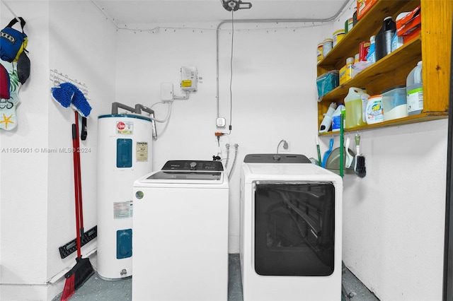 clothes washing area with separate washer and dryer and water heater