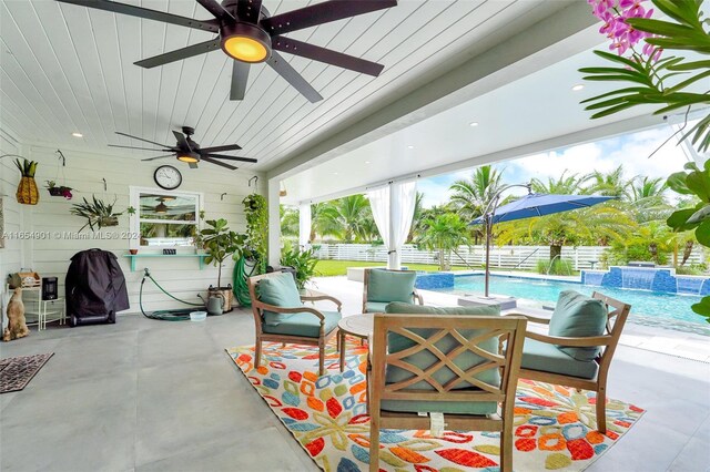 view of patio / terrace with pool water feature, ceiling fan, a fenced in pool, and an outdoor hangout area