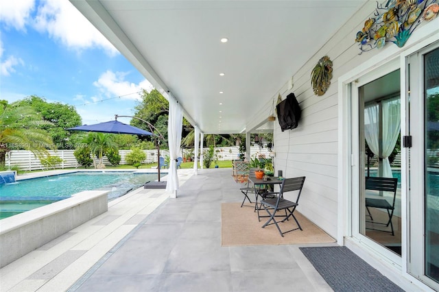 view of patio with pool water feature and a fenced in pool