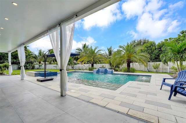 view of swimming pool featuring pool water feature and a patio area