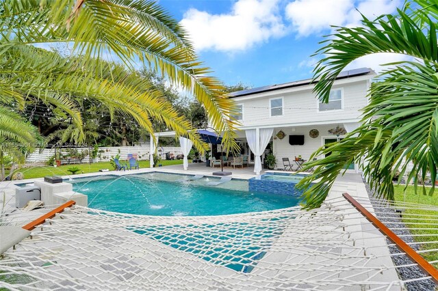 view of swimming pool featuring a patio area and pool water feature