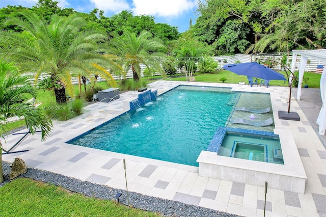 view of pool featuring a patio area, an in ground hot tub, a grill, and pool water feature