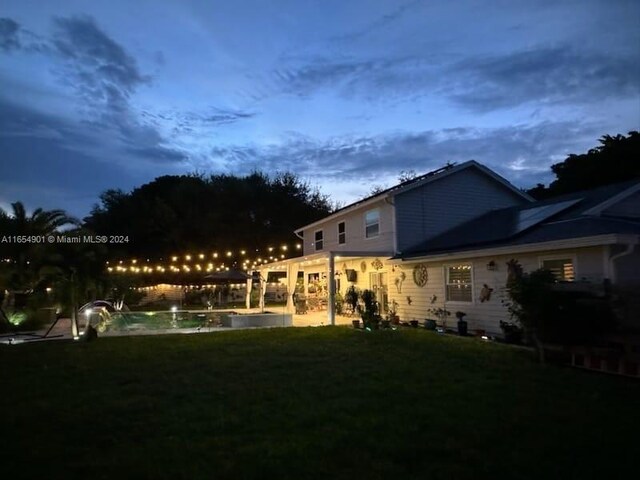 yard at dusk featuring a patio area