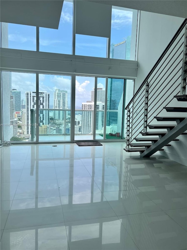 interior space with a high ceiling and tile patterned flooring