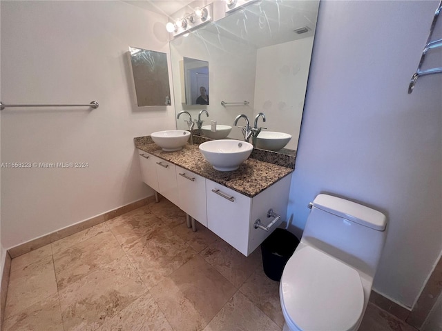 bathroom featuring vanity and toilet