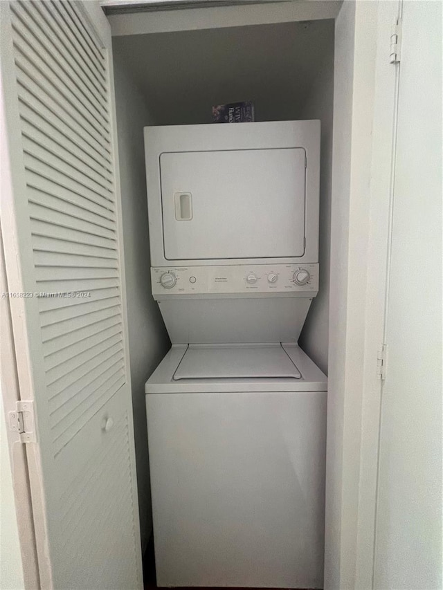 laundry area with stacked washing maching and dryer