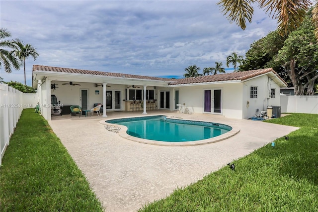 view of pool featuring ceiling fan, a patio, french doors, central AC, and a lawn