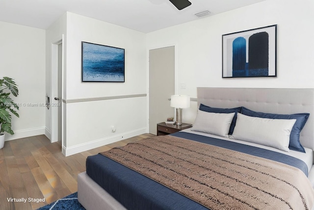 bedroom with dark wood-type flooring and ceiling fan