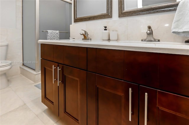 bathroom featuring vanity, tile patterned floors, toilet, and walk in shower