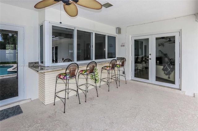 view of patio with french doors and ceiling fan