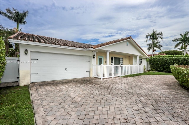 view of front of home featuring covered porch and a garage