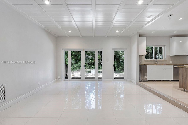 unfurnished living room with wooden ceiling and light tile patterned floors