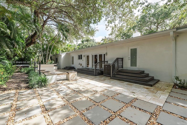 rear view of house with a patio area and french doors