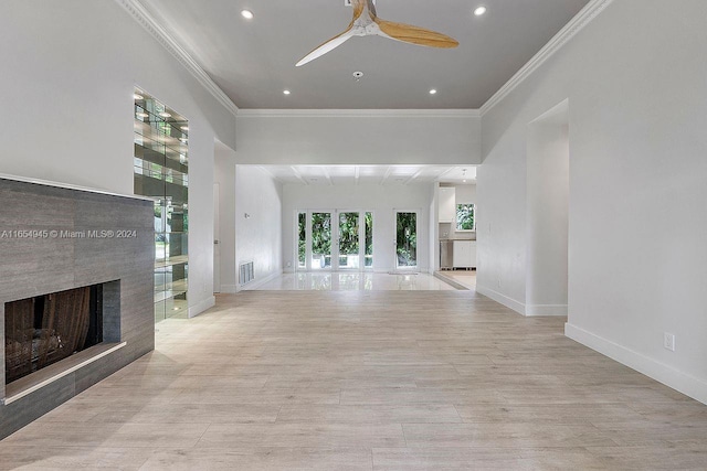 unfurnished living room with a ceiling fan, visible vents, baseboards, a multi sided fireplace, and crown molding