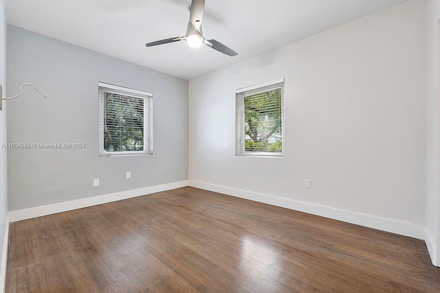 spare room with ceiling fan and wood-type flooring