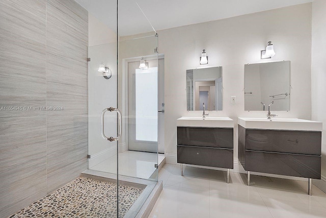 bathroom with vanity, tile walls, a shower with shower door, and tile patterned floors