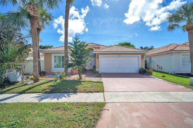 mediterranean / spanish-style house with a garage and a front lawn