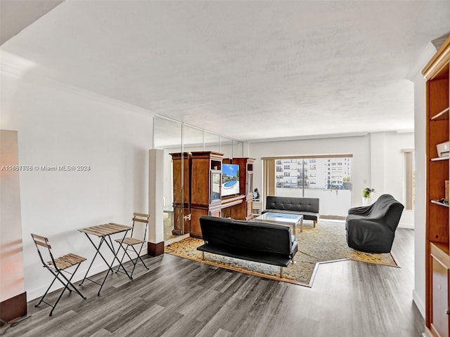 living room with ornamental molding and hardwood / wood-style flooring