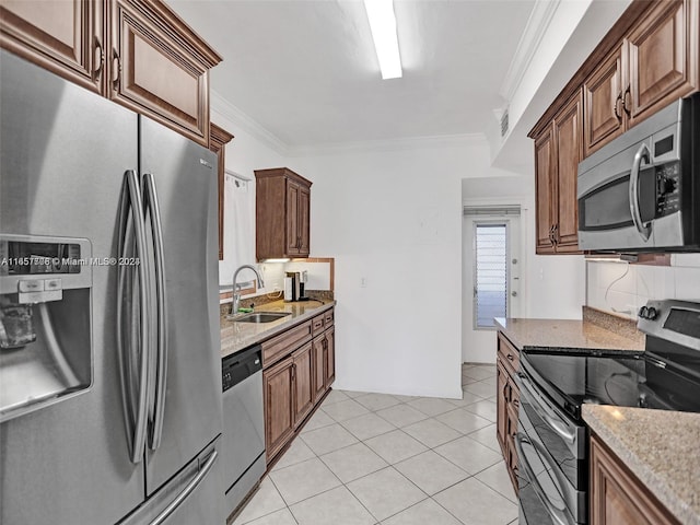 kitchen featuring light tile patterned floors, sink, light stone countertops, and appliances with stainless steel finishes