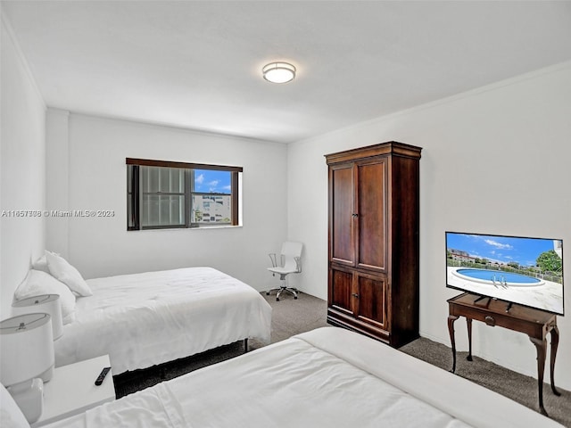 bedroom with crown molding, carpet flooring, and multiple windows