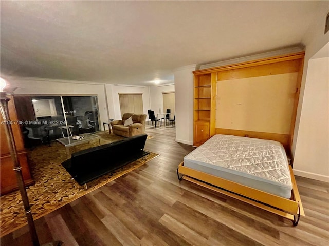 bedroom with dark hardwood / wood-style floors