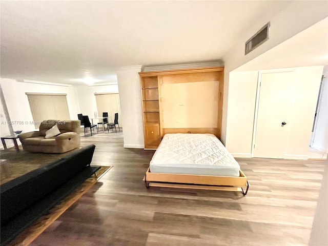 bedroom with dark hardwood / wood-style floors