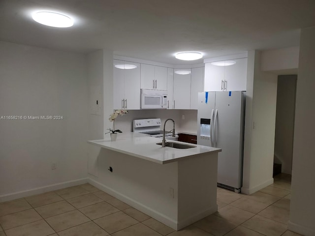 kitchen with white cabinets, white appliances, sink, kitchen peninsula, and light tile patterned flooring