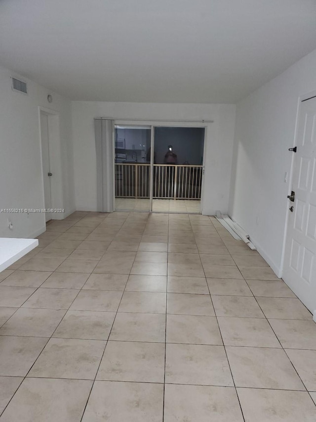 spare room featuring light tile patterned floors