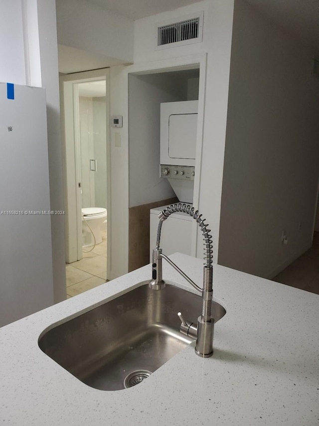 details featuring light stone counters and sink