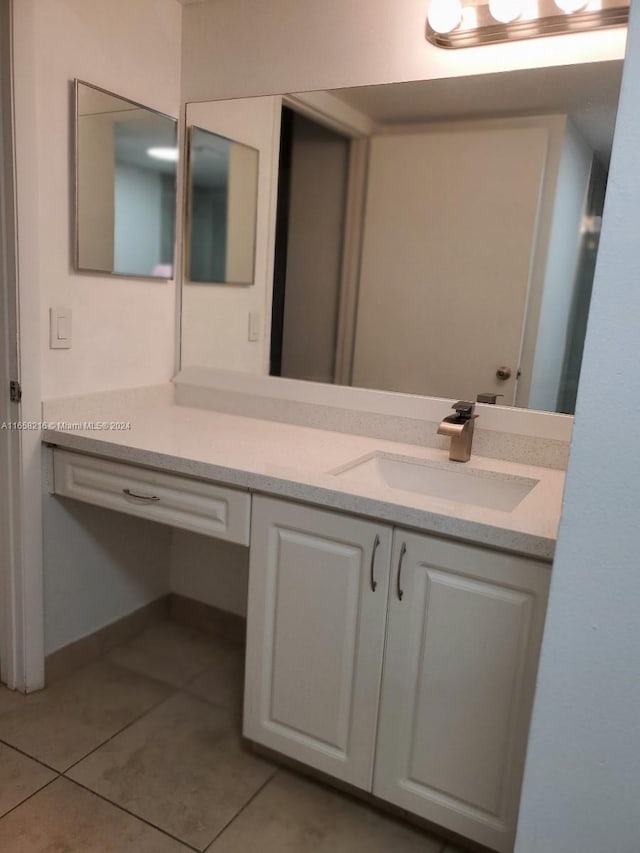 bathroom with tile patterned floors and vanity