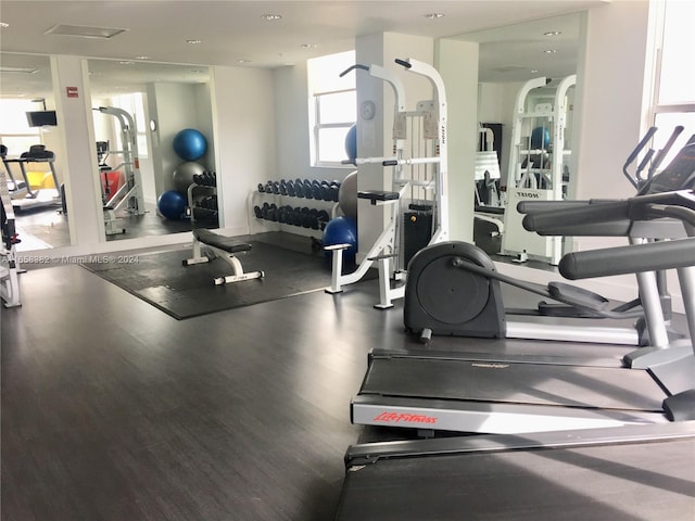 workout area with hardwood / wood-style flooring