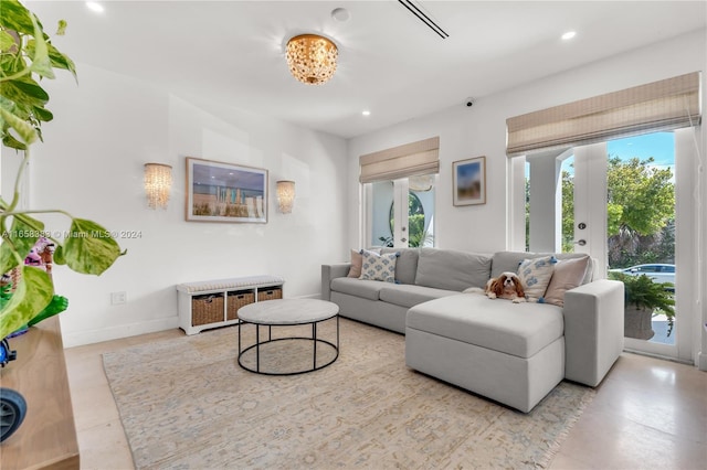 living room featuring french doors and an inviting chandelier