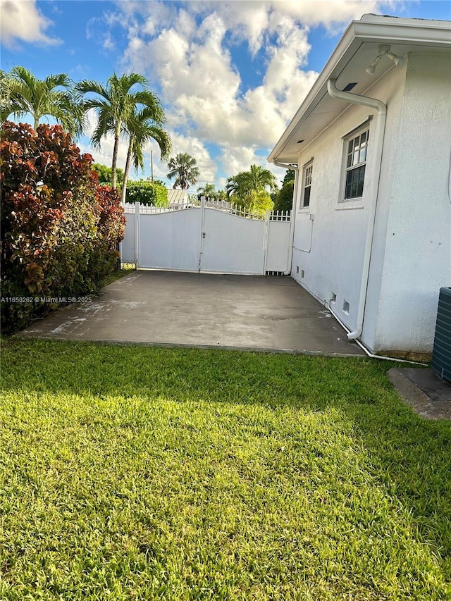 view of yard with a patio area and central air condition unit