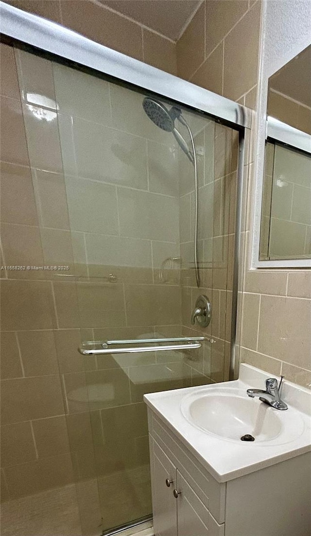 bathroom with vanity and a shower with shower door