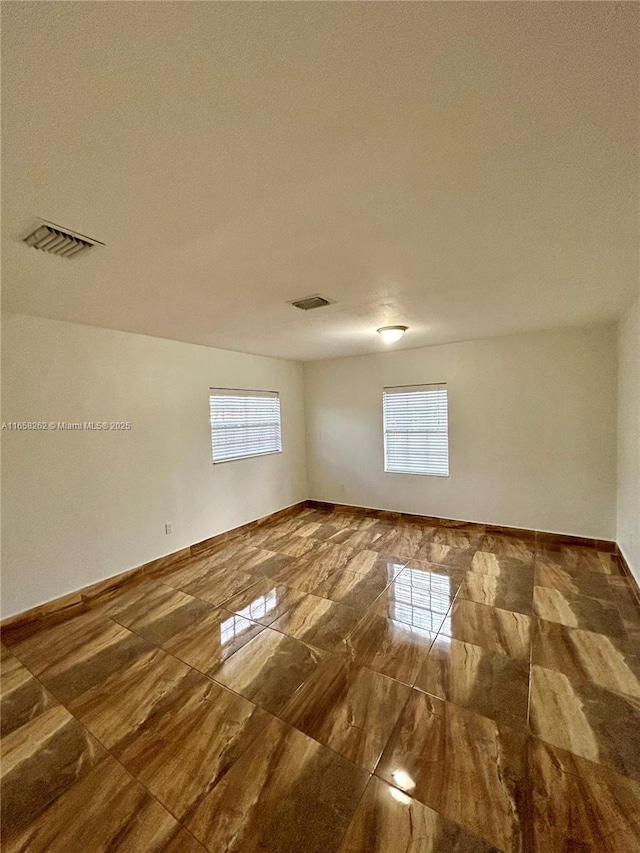 spare room with a textured ceiling and a healthy amount of sunlight