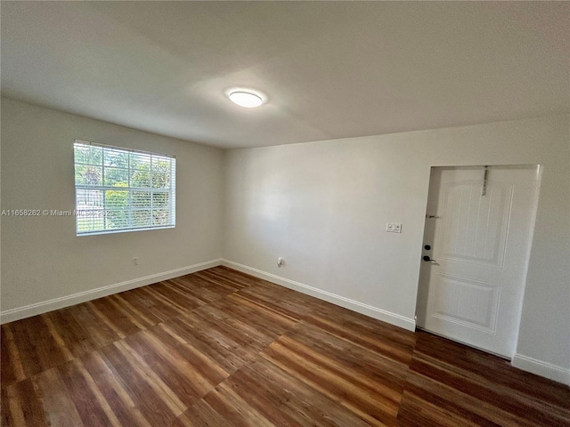 empty room with dark hardwood / wood-style floors