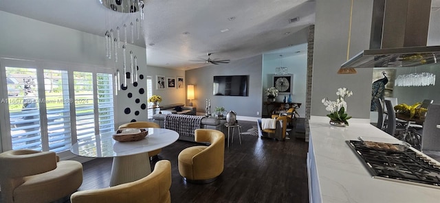 dining room featuring lofted ceiling, ceiling fan, dark hardwood / wood-style flooring, and a textured ceiling