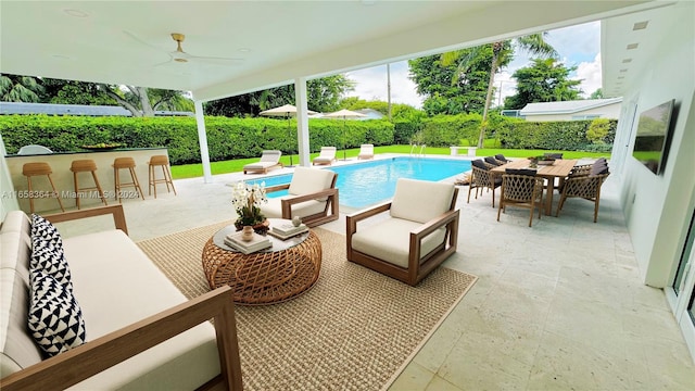 view of swimming pool with an outdoor living space, ceiling fan, an outdoor bar, and a patio