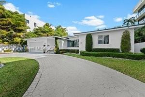 single story home featuring a garage and a front lawn