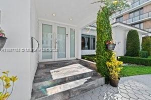 3551 E Glencoe St, Miami, FL 33133 - property entrance with french doors and stucco siding