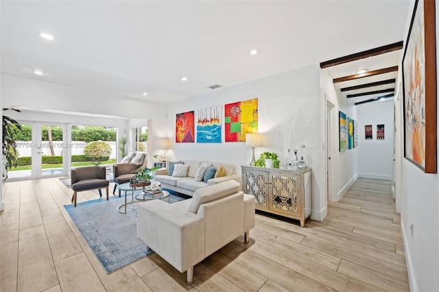 living area featuring visible vents, beam ceiling, light wood-style flooring, recessed lighting, and french doors